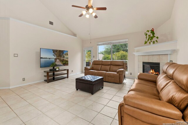 26223 Cuyahoga Cir, San Antonio, TX 78260 - living room with a tiled fireplace, light tile patterned flooring, a ceiling fan, high vaulted ceiling, and baseboards