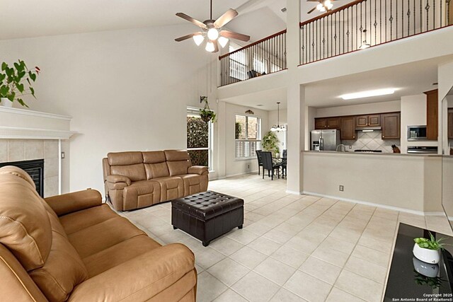 26223 Cuyahoga Cir, San Antonio, TX 78260 - living area with a ceiling fan, light tile patterned floors, a high ceiling, and a tiled fireplace