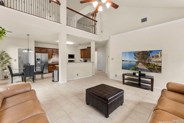 26223 Cuyahoga Cir, San Antonio, TX 78260 - living room with a ceiling fan, light tile patterned flooring, high vaulted ceiling, a chandelier, and baseboards