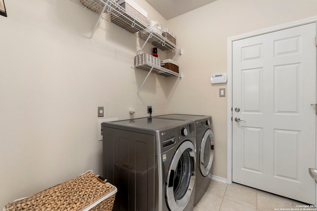 26223 Cuyahoga Cir, San Antonio, TX 78260 - laundry area featuring light tile patterned floors, washing machine and clothes dryer, and baseboards