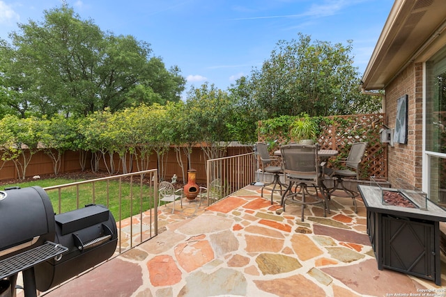 26223 Cuyahoga Cir, San Antonio, TX 78260 - fenced backyard featuring a fire pit, outdoor dining space, a patio area, and grilling area