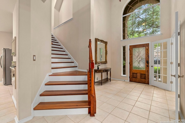 26223 Cuyahoga Cir, San Antonio, TX 78260 - foyer featuring a high ceiling, light tile patterned flooring, stairway, and baseboards