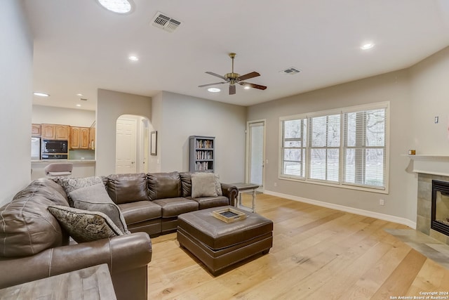 154 Roseheart, San Antonio, TX 78259 - living area featuring arched walkways, light wood-style floors, a ceiling fan, a fireplace, and recessed lighting