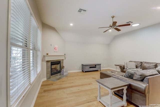 154 Roseheart, San Antonio, TX 78259 - living area with ceiling fan, a tile fireplace, light wood-style floors, vaulted ceiling, and baseboards