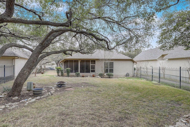 154 Roseheart, San Antonio, TX 78259 - back of property featuring a sunroom, an outdoor fire pit, and stucco siding