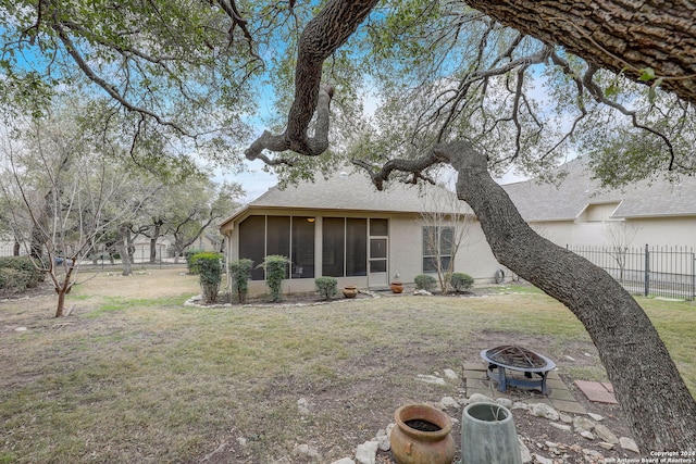 154 Roseheart, San Antonio, TX 78259 - rear view of property featuring a sunroom, a fire pit, and a shingled roof