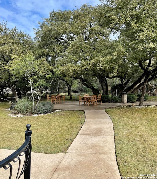 154 Roseheart, San Antonio, TX 78259 - view of property's community with a lawn, a patio, and view of wooded area