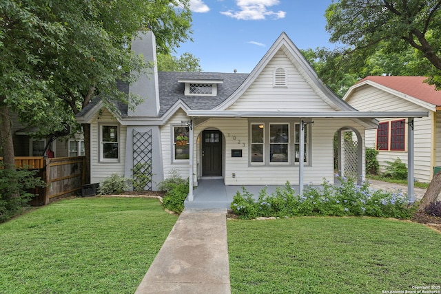 1023 Gramercy, San Antonio, TX 78201 - view of front facade with covered porch, roof with shingles, and cooling unit