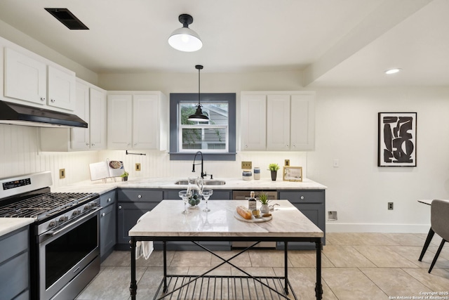 1023 Gramercy, San Antonio, TX 78201 - kitchen featuring stainless steel range with gas stovetop, a sink, under cabinet range hood, light countertops, and white cabinetry
