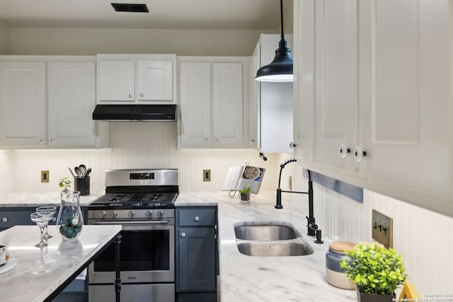 1023 Gramercy, San Antonio, TX 78201 - kitchen featuring stainless steel range with gas stovetop, under cabinet range hood, a sink, white cabinetry, and light stone counters