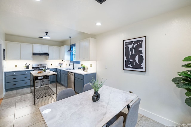 1023 Gramercy, San Antonio, TX 78201 - kitchen with a sink, stainless steel appliances, under cabinet range hood, white cabinets, and light countertops