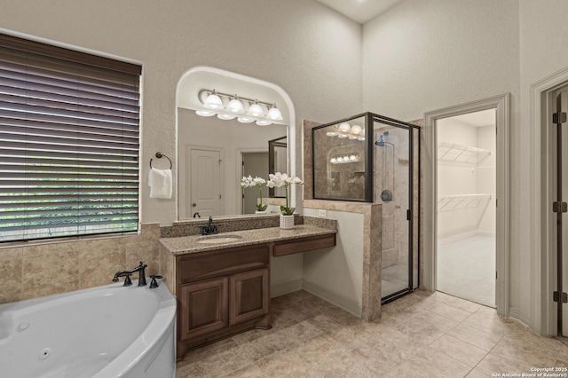 1238 Via Belcanto, San Antonio, TX 78260 - bathroom featuring a shower stall, a tub with jets, vanity, a walk in closet, and tile patterned flooring