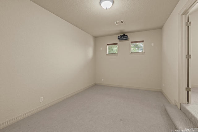 1238 Via Belcanto, San Antonio, TX 78260 - unfurnished room with light colored carpet, a textured ceiling, and baseboards