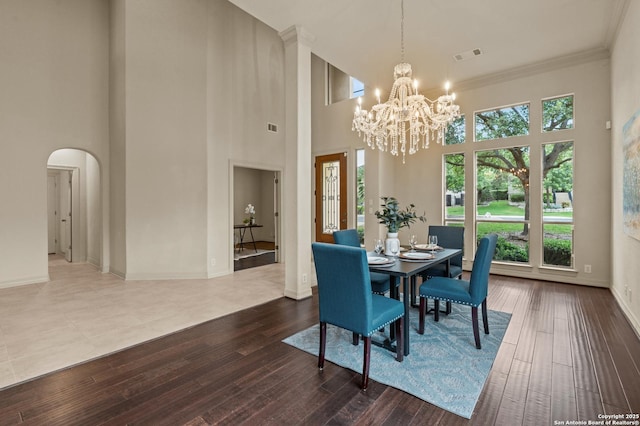 1238 Via Belcanto, San Antonio, TX 78260 - dining area featuring healthy amount of natural light, arched walkways, a towering ceiling, a chandelier, and baseboards