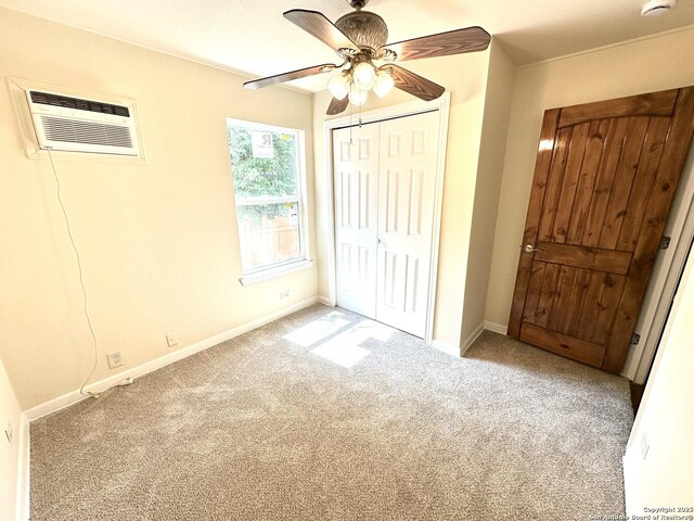 207 Freiling, San Antonio, TX 78213 - unfurnished bedroom featuring an AC wall unit, carpet flooring, a closet, and baseboards