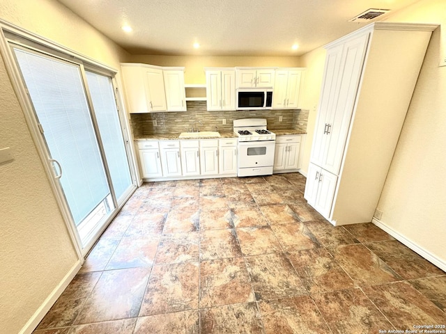 207 Freiling, San Antonio, TX 78213 - kitchen featuring white appliances, backsplash, open shelves, baseboards, and white cabinetry