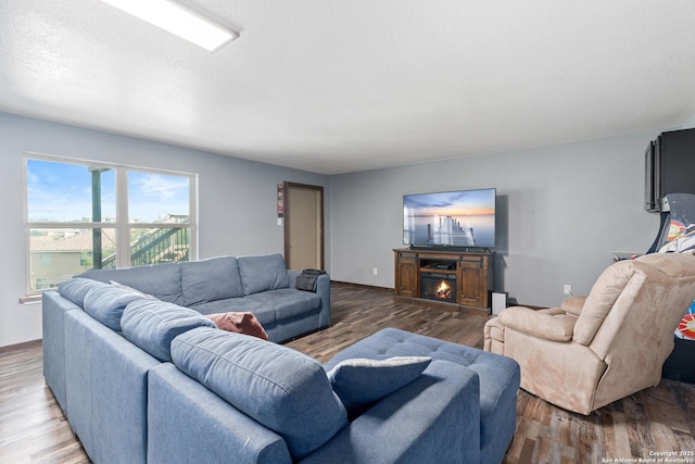 17906 Via Del Arbol, San Antonio, TX 78257 - living area with wood finished floors and a warm lit fireplace