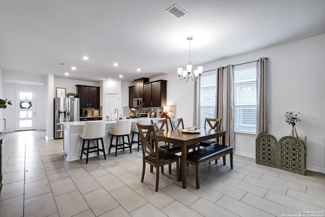 5219 Wolf Bane, San Antonio, TX 78261 - dining space featuring a chandelier, recessed lighting, light tile patterned flooring, and baseboards