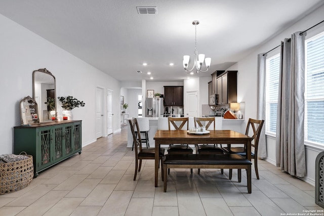 5219 Wolf Bane, San Antonio, TX 78261 - dining area featuring a chandelier, plenty of natural light, recessed lighting, baseboards, and light tile patterned flooring