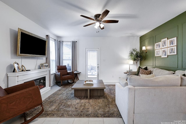 5219 Wolf Bane, San Antonio, TX 78261 - living room featuring ceiling fan, a glass covered fireplace, and tile patterned flooring