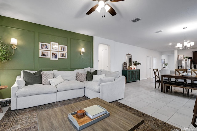 5219 Wolf Bane, San Antonio, TX 78261 - tiled living area featuring ceiling fan, arched walkways, a chandelier, and a decorative wall