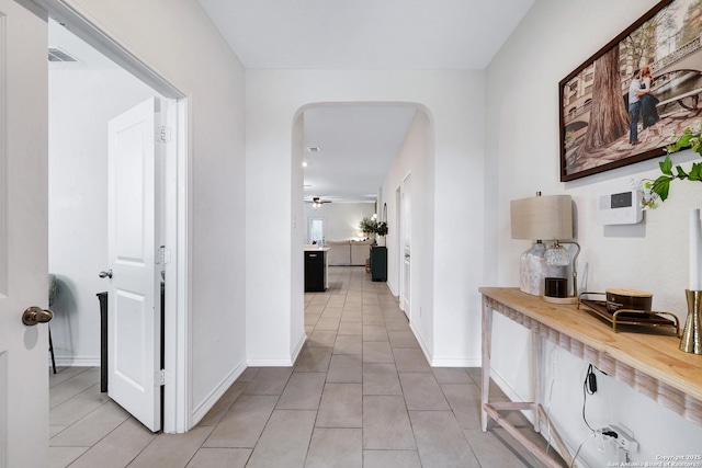 5219 Wolf Bane, San Antonio, TX 78261 - corridor featuring arched walkways, light tile patterned floors, and baseboards