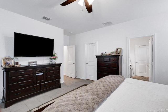 5219 Wolf Bane, San Antonio, TX 78261 - bedroom featuring light tile patterned flooring, ensuite bathroom, ceiling fan, and baseboards