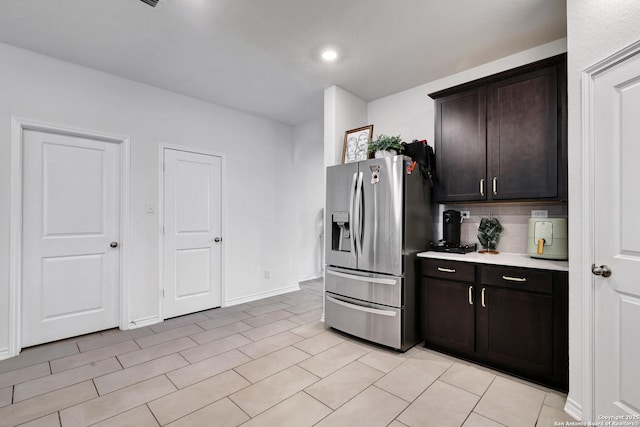 5219 Wolf Bane, San Antonio, TX 78261 - kitchen with stainless steel fridge with ice dispenser, light countertops, backsplash, dark brown cabinets, and baseboards