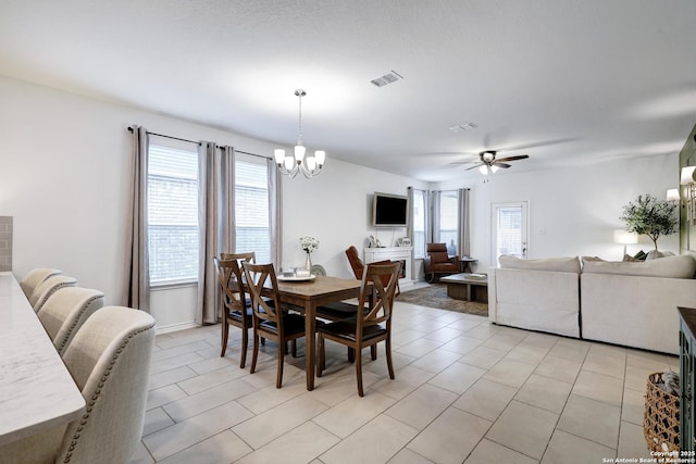 5219 Wolf Bane, San Antonio, TX 78261 - dining area featuring a chandelier, ceiling fan, and light tile patterned floors