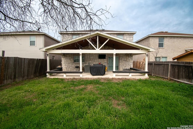 9668 Shorebird, San Antonio, TX 78245 - rear view of house featuring a patio area, stone siding, and central AC