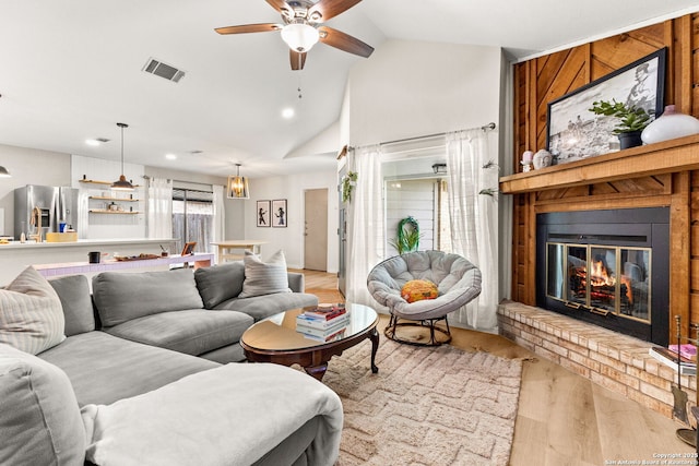 922 Sundance, New Braunfels, TX 78130 - living room featuring light wood-style flooring, vaulted ceiling, a ceiling fan, a brick fireplace, and recessed lighting