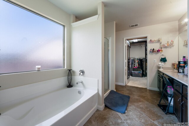 4310 Gambels Quail, Converse, TX 78109 - full bath with a stall shower, a garden tub, a spacious closet, vanity, and baseboards