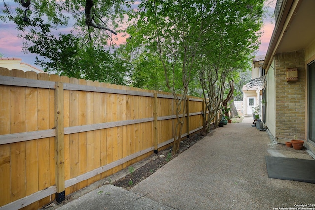 11700 Mission Trce, San Antonio, TX 78230 - patio terrace at dusk featuring a fenced backyard and a patio