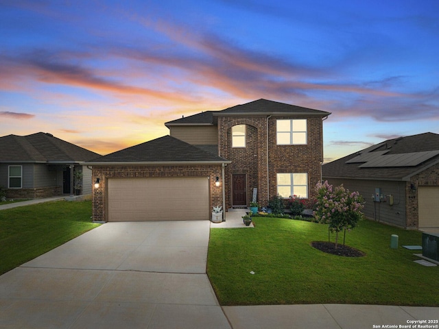 700 Ridge Vw, Seguin, TX 78155 - traditional-style home featuring an attached garage, brick siding, a front yard, driveway, and a shingled roof