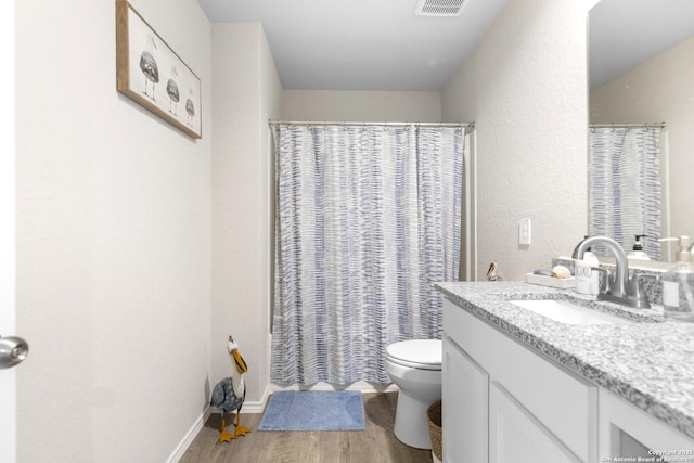 700 Ridge Vw, Seguin, TX 78155 - full bath with wood finished floors, vanity, toilet, a shower with curtain, and baseboards