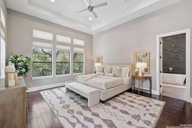 17706 Wild Basin, San Antonio, TX 78258 - bedroom with dark wood finished floors, baseboards, recessed lighting, a raised ceiling, and ceiling fan