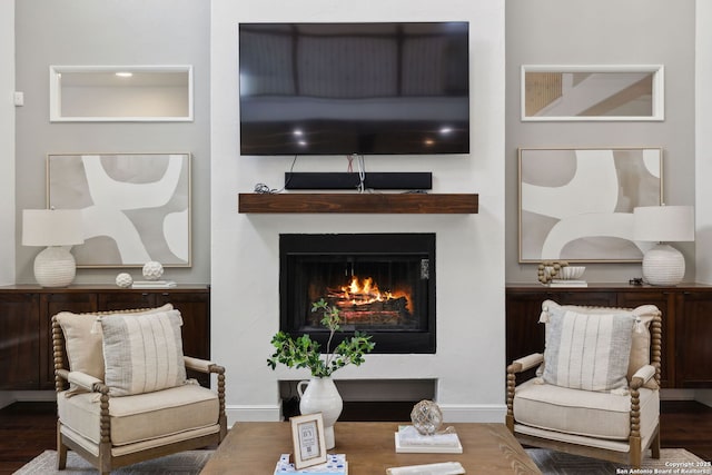 17706 Wild Basin, San Antonio, TX 78258 - living area featuring a lit fireplace, wood finished floors, and baseboards