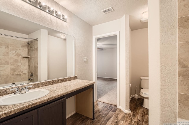 10110 Raspberry Oak, San Antonio, TX 78223 - full bath with wood finished floors, toilet, vanity, and a textured ceiling
