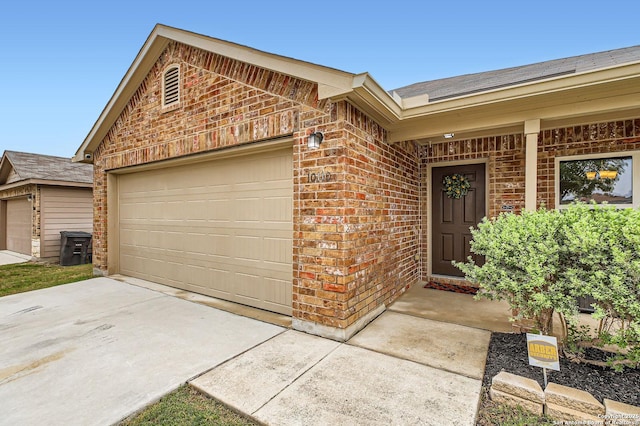 10110 Raspberry Oak, San Antonio, TX 78223 - entrance to property featuring brick siding, driveway, and an attached garage