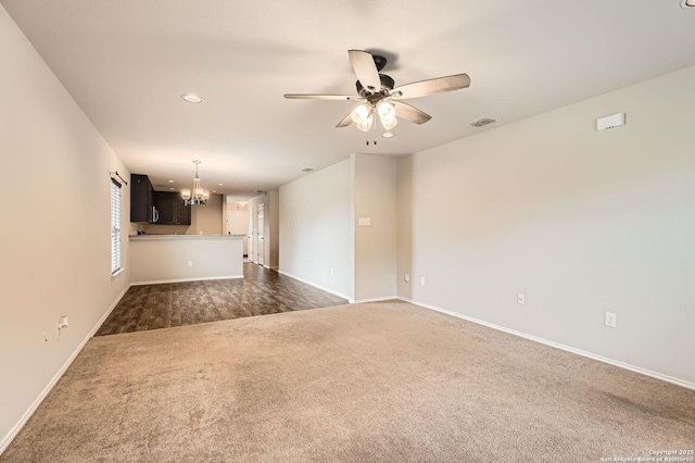 10110 Raspberry Oak, San Antonio, TX 78223 - unfurnished living room with dark colored carpet, a ceiling fan, a chandelier, baseboards, and recessed lighting