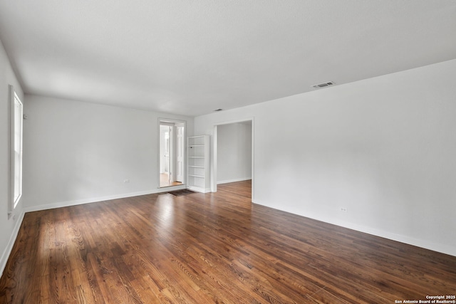 113 E Sunset, San Antonio, TX 78209 - unfurnished room featuring baseboards and dark wood-style floors