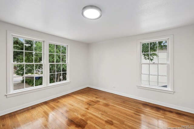 113 E Sunset, San Antonio, TX 78209 - empty room with baseboards, healthy amount of natural light, and light wood-style flooring