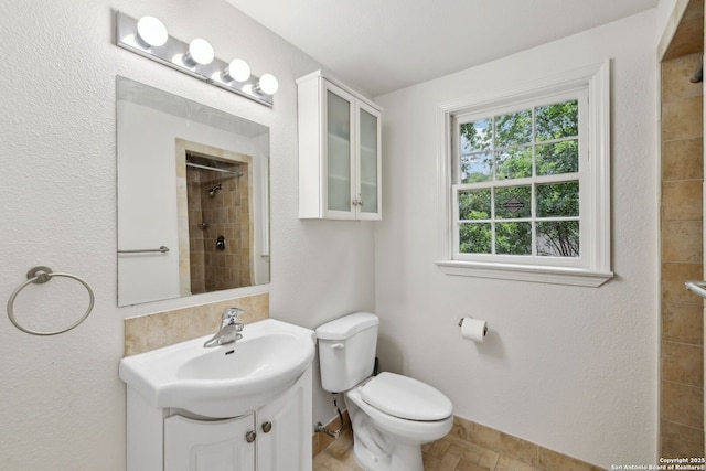 113 E Sunset, San Antonio, TX 78209 - bathroom featuring tiled shower, toilet, vanity, and baseboards