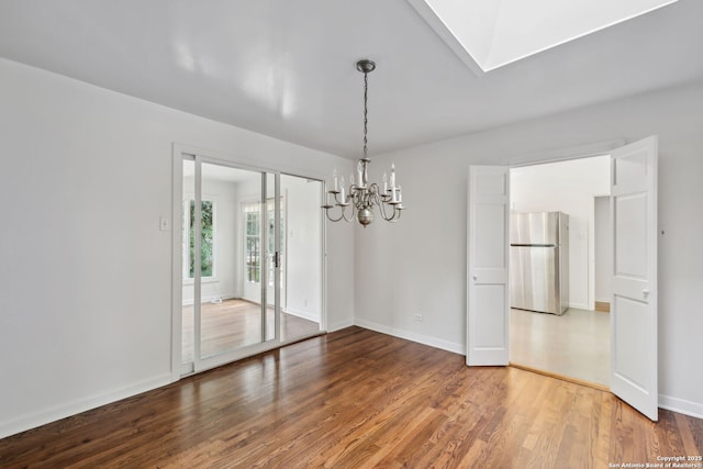 113 E Sunset, San Antonio, TX 78209 - spare room featuring a chandelier, wood finished floors, and baseboards