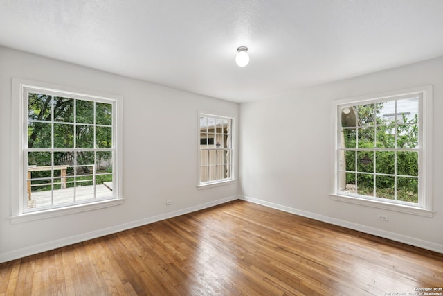 113 E Sunset, San Antonio, TX 78209 - unfurnished room featuring baseboards and hardwood / wood-style floors