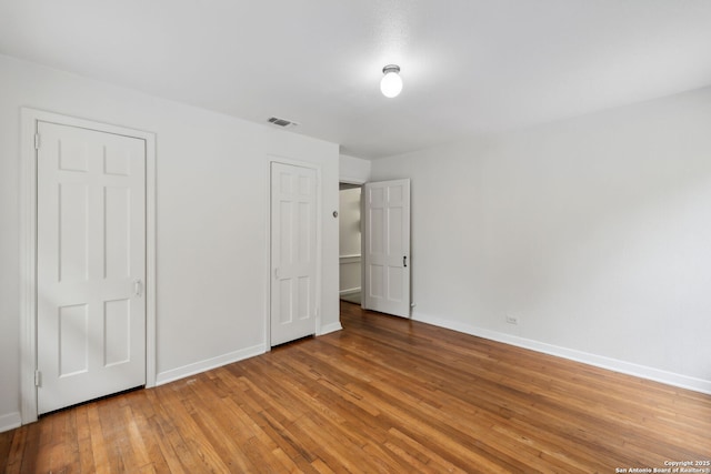 113 E Sunset, San Antonio, TX 78209 - unfurnished bedroom with wood-type flooring and baseboards