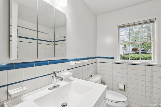 113 E Sunset, San Antonio, TX 78209 - bathroom with a sink, tile walls, toilet, and wainscoting