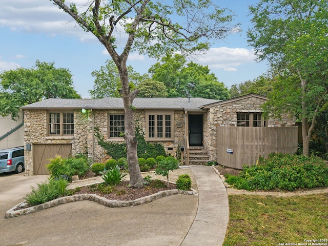 113 E Sunset, San Antonio, TX 78209 - mid-century home featuring stone siding, roof with shingles, and concrete driveway