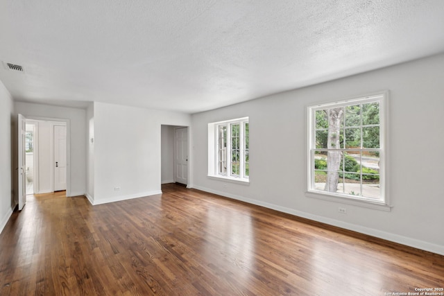 113 E Sunset, San Antonio, TX 78209 - spare room featuring dark wood finished floors, baseboards, and a textured ceiling