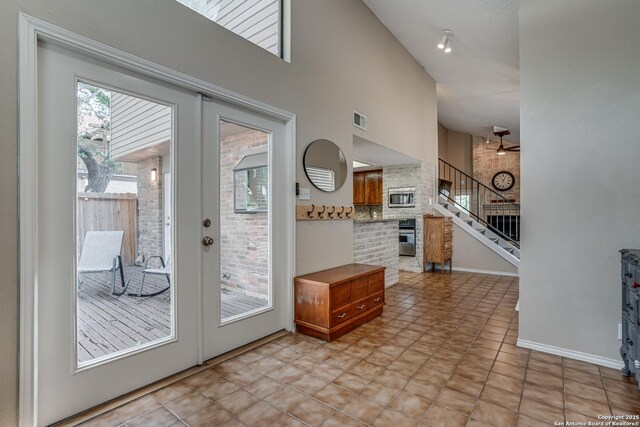13426 Marceline, San Antonio, TX 78232 - entryway featuring stairway, high vaulted ceiling, and baseboards